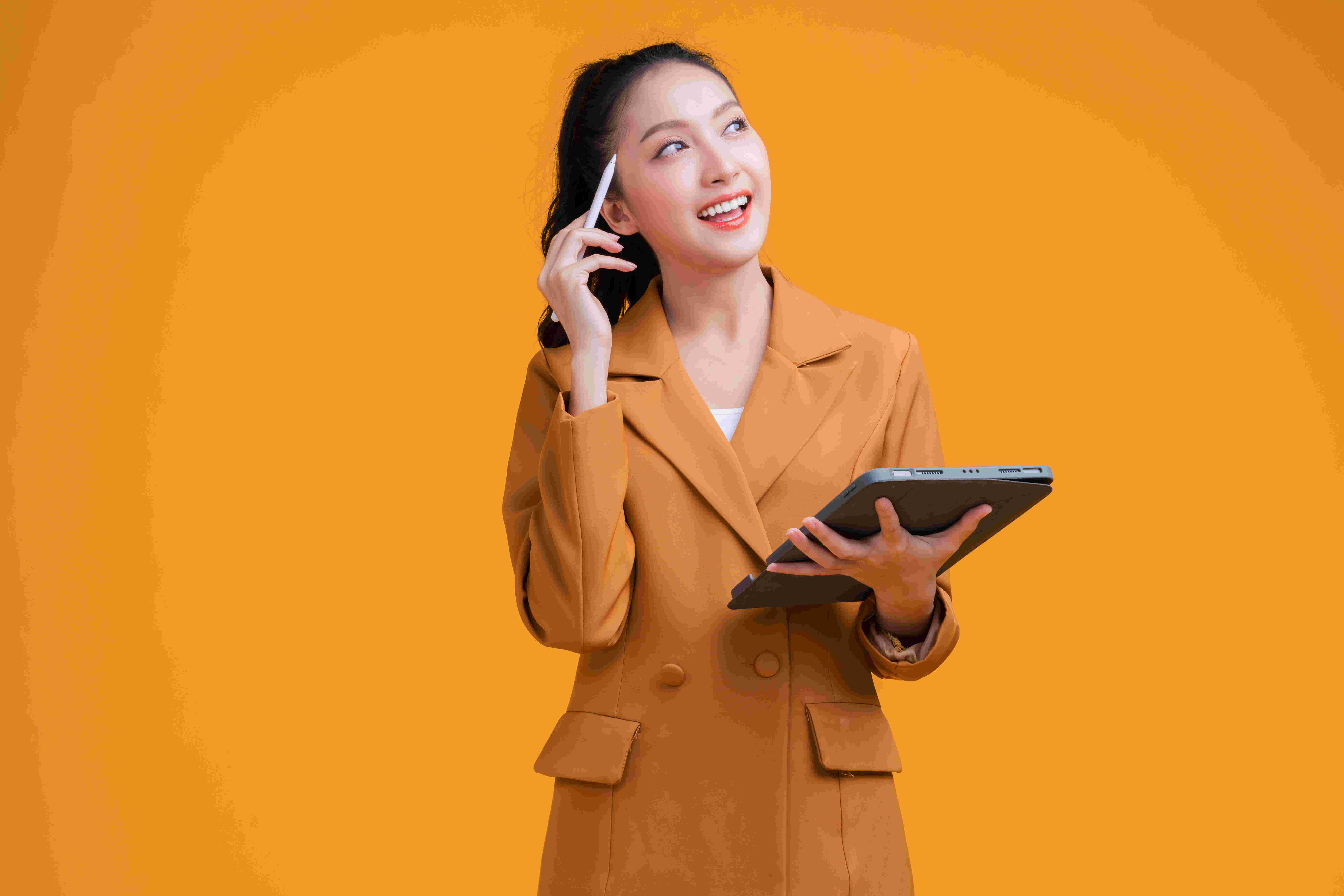 casual smart asian female business woman hand using tablet business management schedule smiling confident cheerful facial expression studio shot yellow background,thinking asian woman in formal cloth